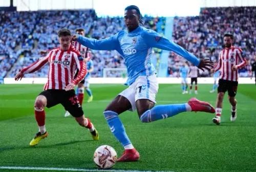 لاعب كوفنتري يحاول السيطرة على الكرة أثناء مواجهة سندرلاند، مع حشد من المشجعين في الملعب.